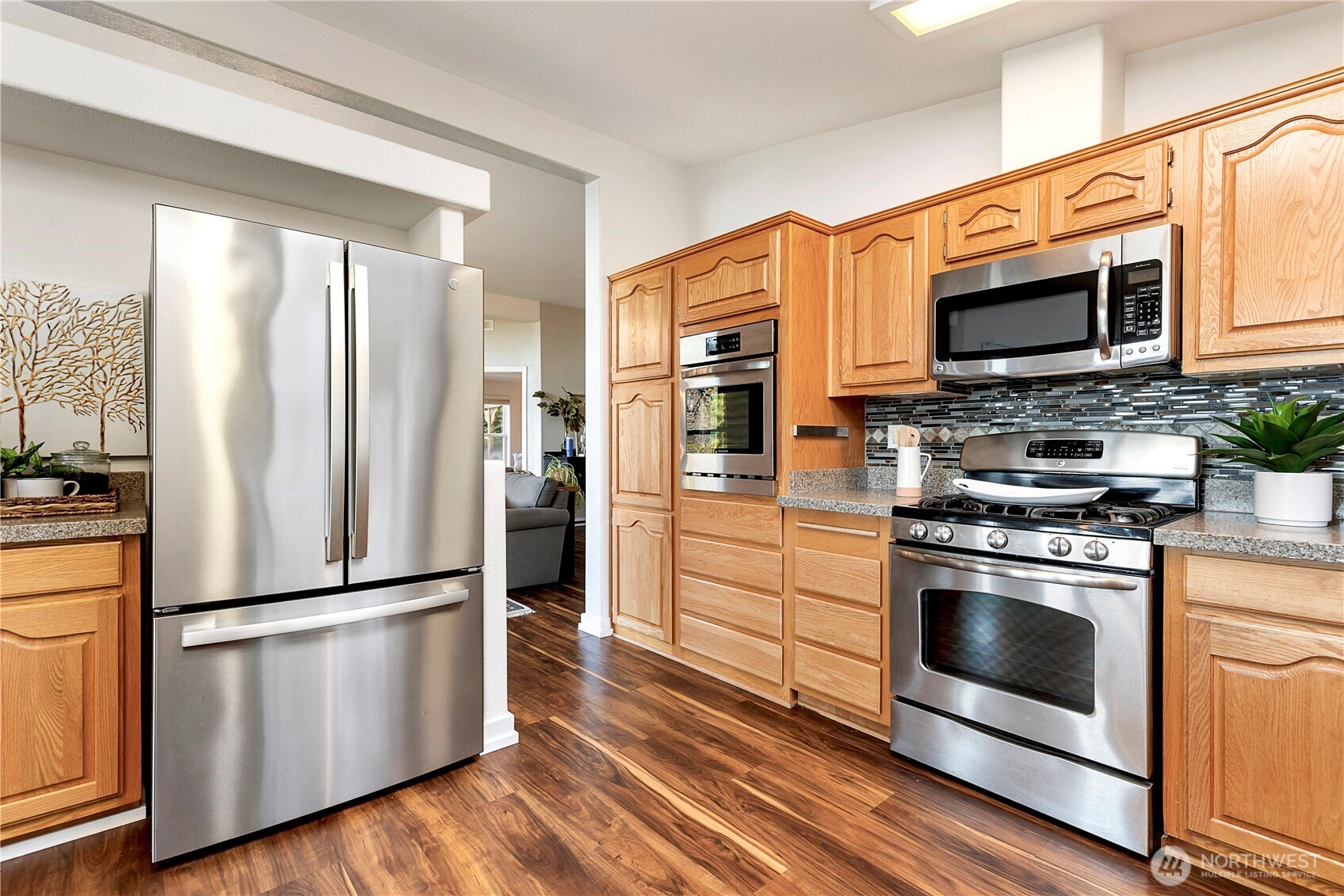 3834 South Passage View Lane Langley, WA 98260 - Photo 23 of 40 a kitchen with stainless steel appliances granite countertop a refrigerator microwave and stove top oven