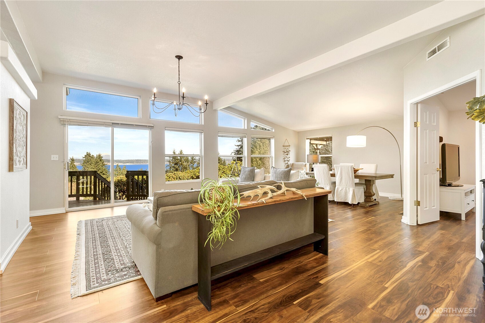 3834 South Passage View Lane Langley, WA 98260 - Photo 24 of 40 a living room with fireplace furniture and a chandelier