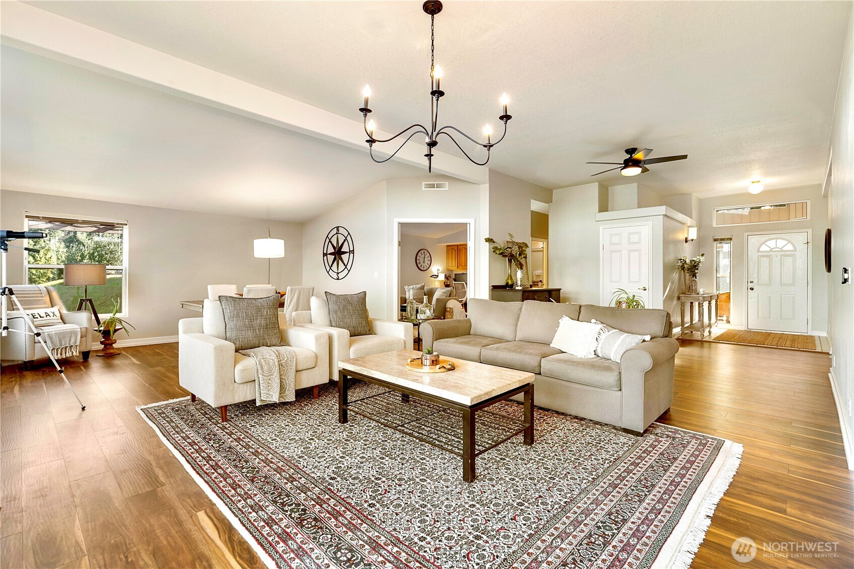3834 South Passage View Lane Langley, WA 98260 - Photo 10 of 40 a living room with furniture and a chandelier
