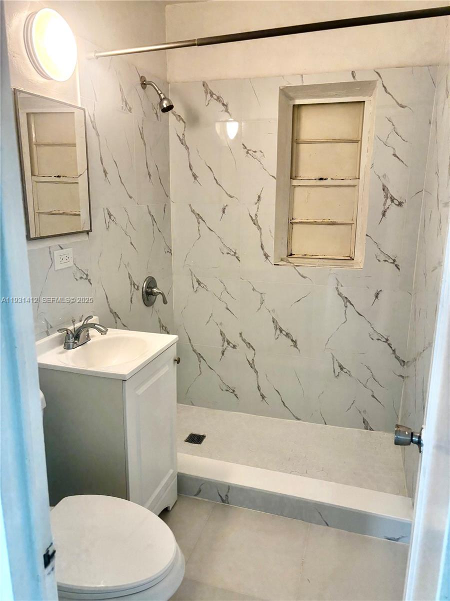 14731 Harding Lane Homestead, FL 33033 - Photo 8 of 10 a bathroom with a sink a toilet and shower