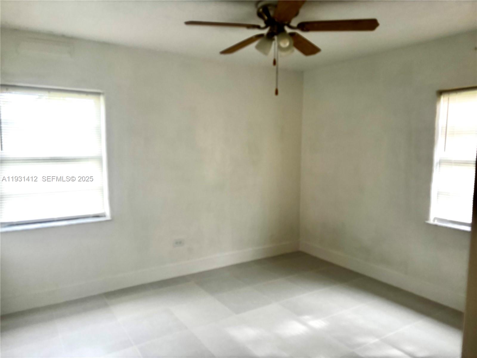 14731 Harding Lane Homestead, FL 33033 - Photo 9 of 10 an empty room with a window and a fan