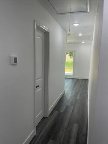 a view of hallway with wooden floor