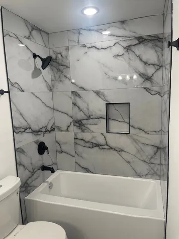 a bathroom with a bathtub and a shower
