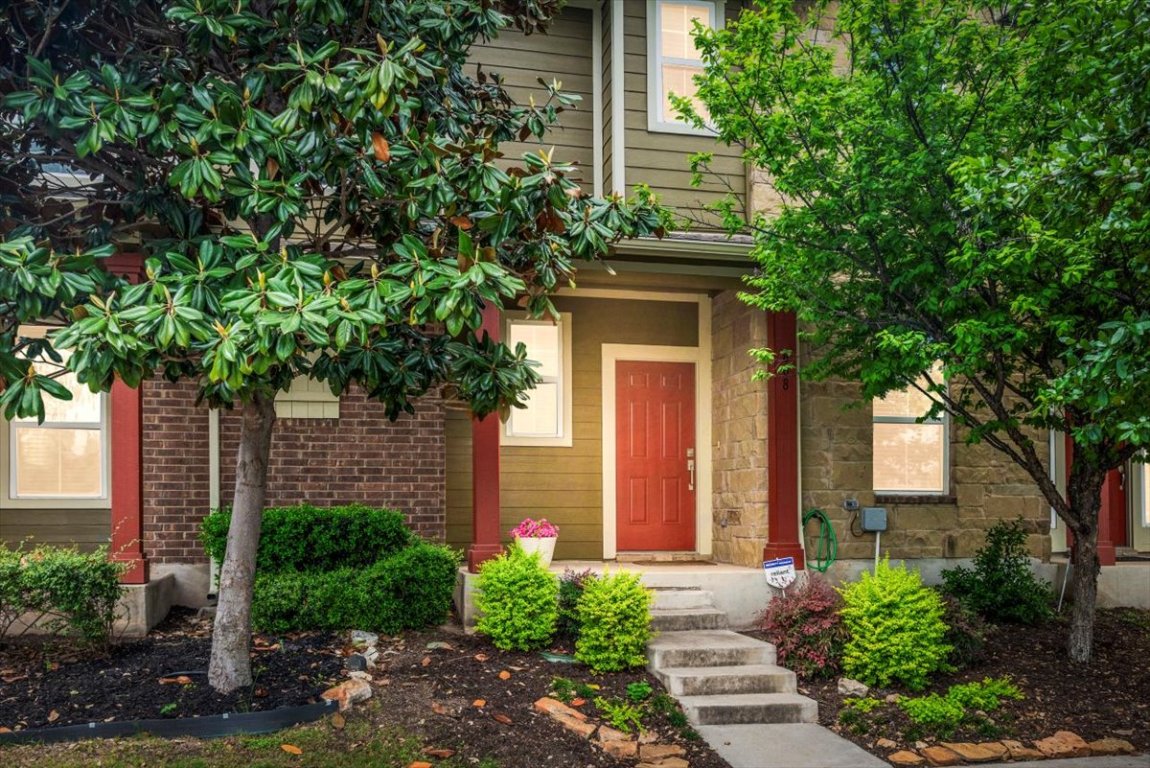 a front view of a house with a garden