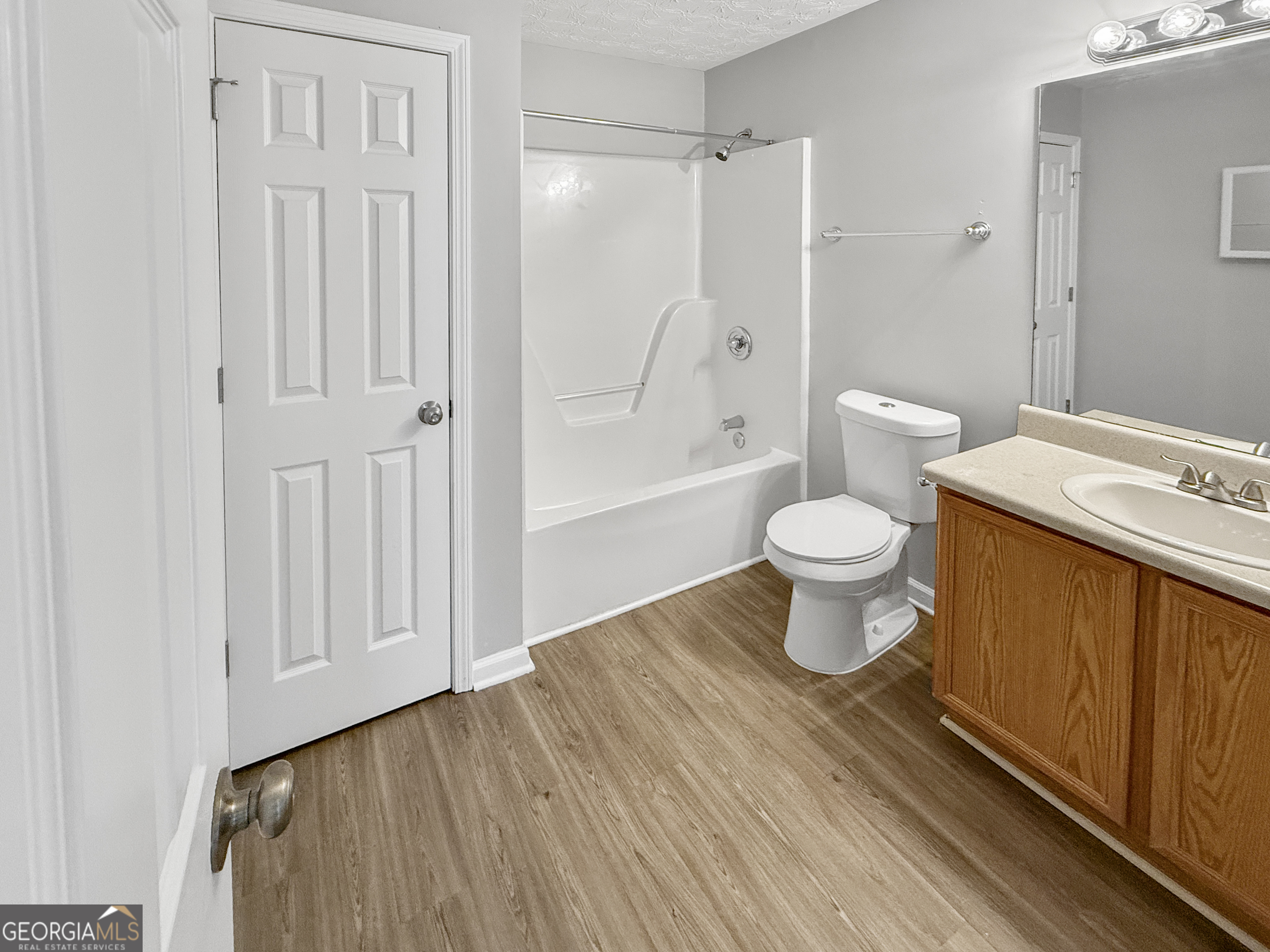 9108 South Sterling Lakes Drive Covington, GA 30014 - Photo 11 of 16 a bathroom with a toilet and a shower