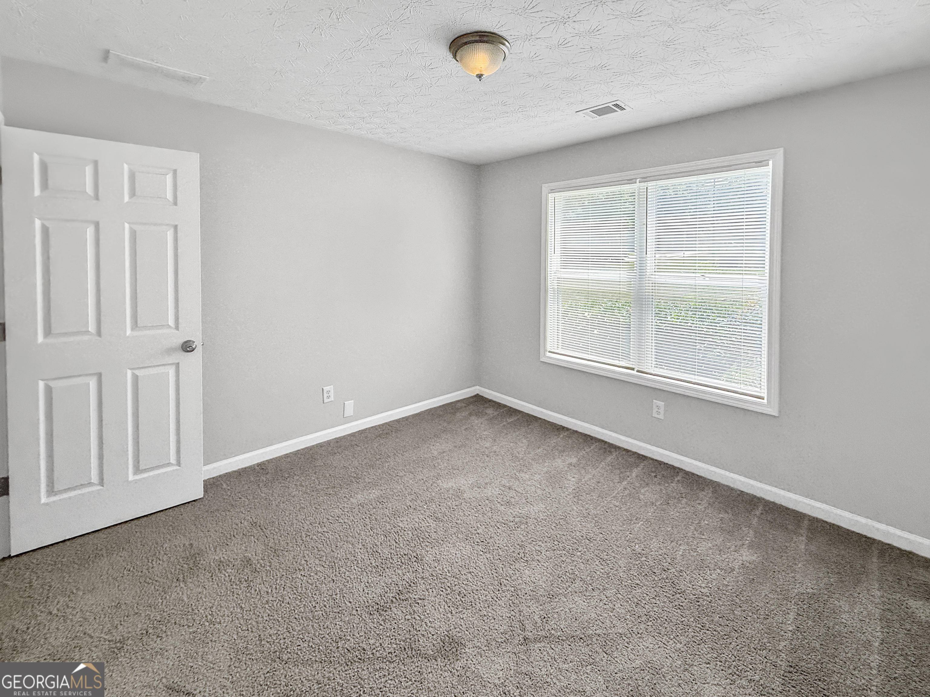 9108 South Sterling Lakes Drive Covington, GA 30014 - Photo 13 of 16 an empty room with a window