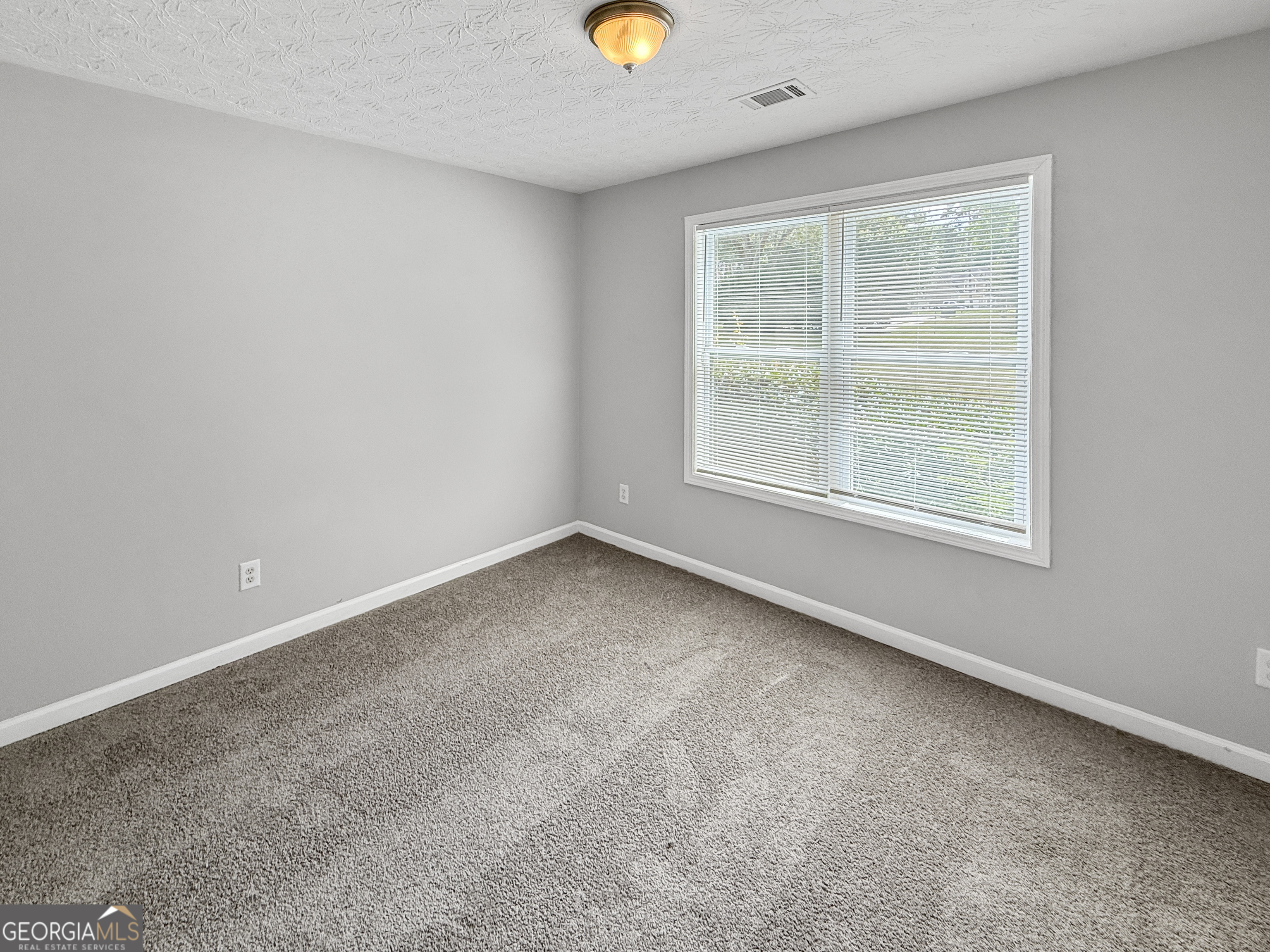 9108 South Sterling Lakes Drive Covington, GA 30014 - Photo 14 of 16 an empty room with a window
