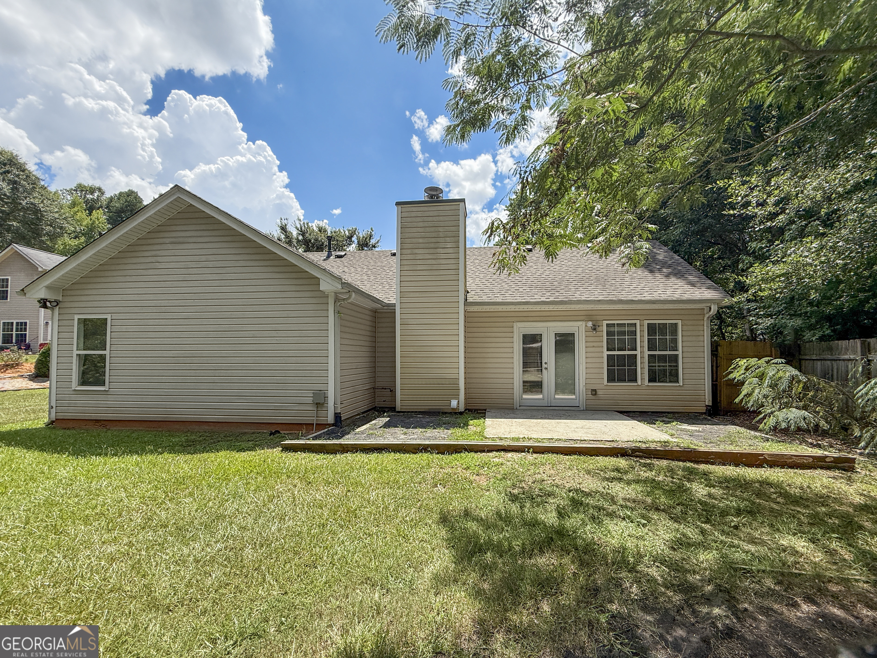 9108 South Sterling Lakes Drive Covington, GA 30014 - Photo 15 of 16 a front view of house with yard and trees around