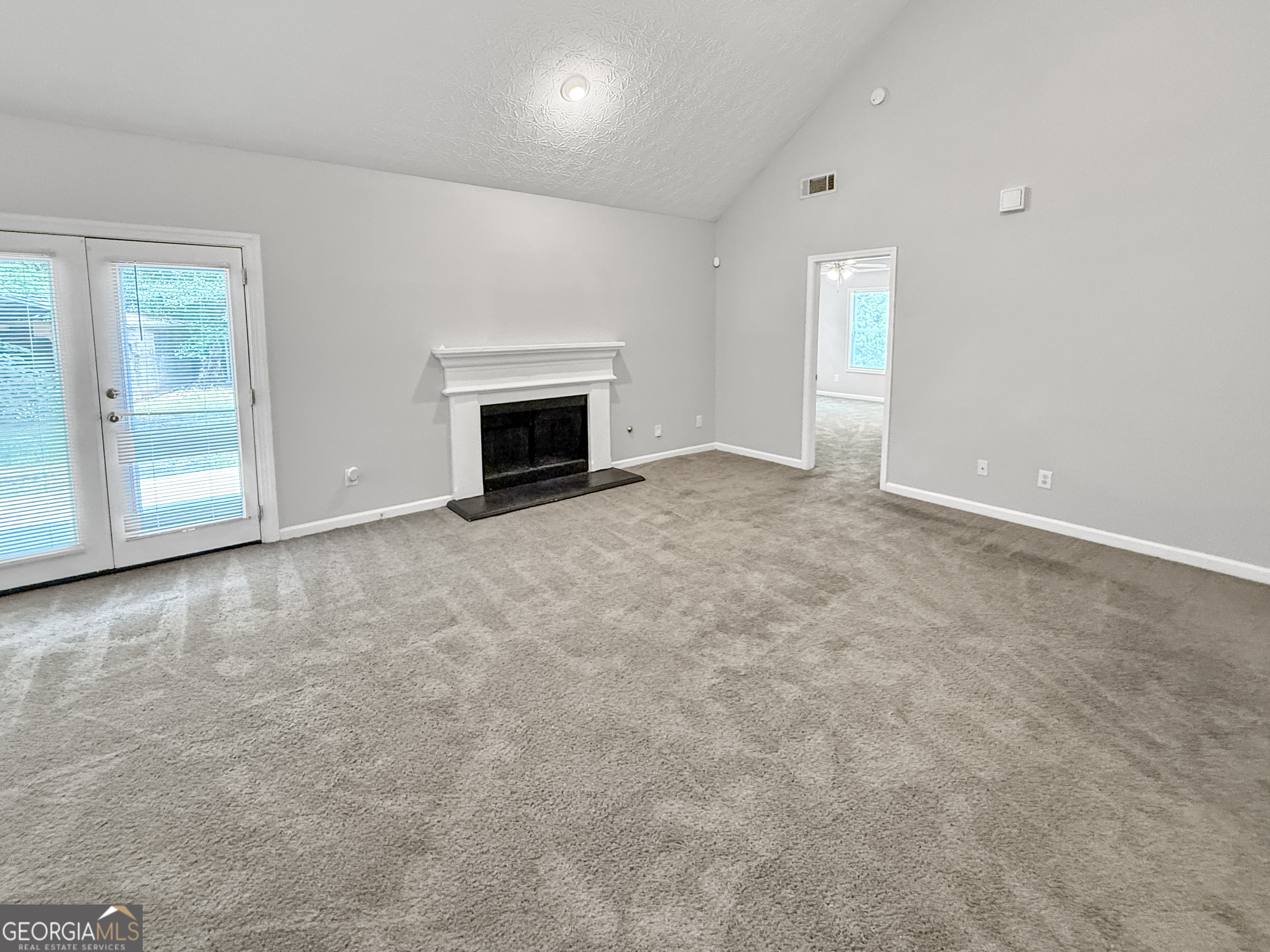 9108 South Sterling Lakes Drive Covington, GA 30014 - Photo 2 of 16 an empty room with windows