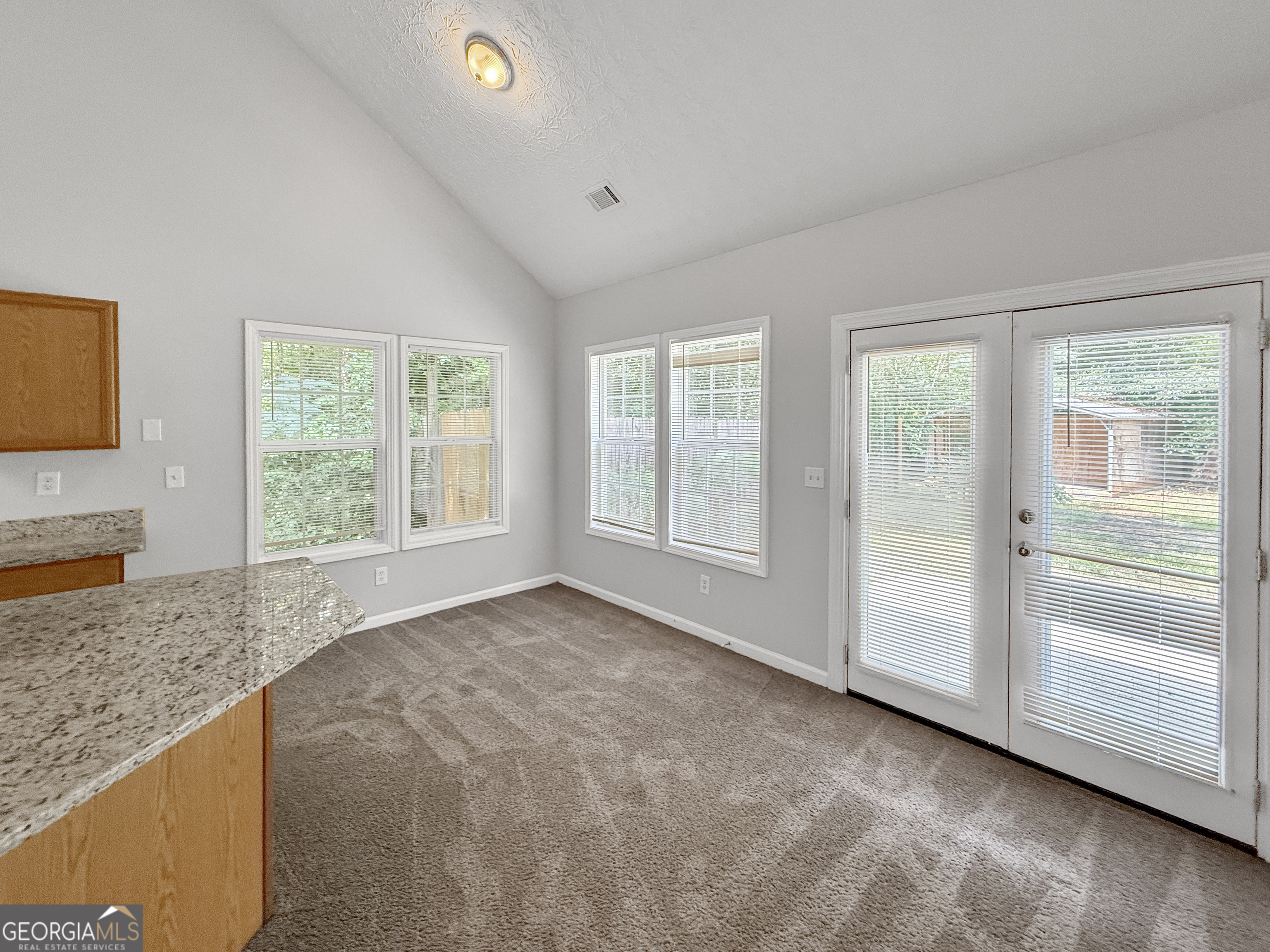9108 South Sterling Lakes Drive Covington, GA 30014 - Photo 3 of 16 a view of an empty room with a window