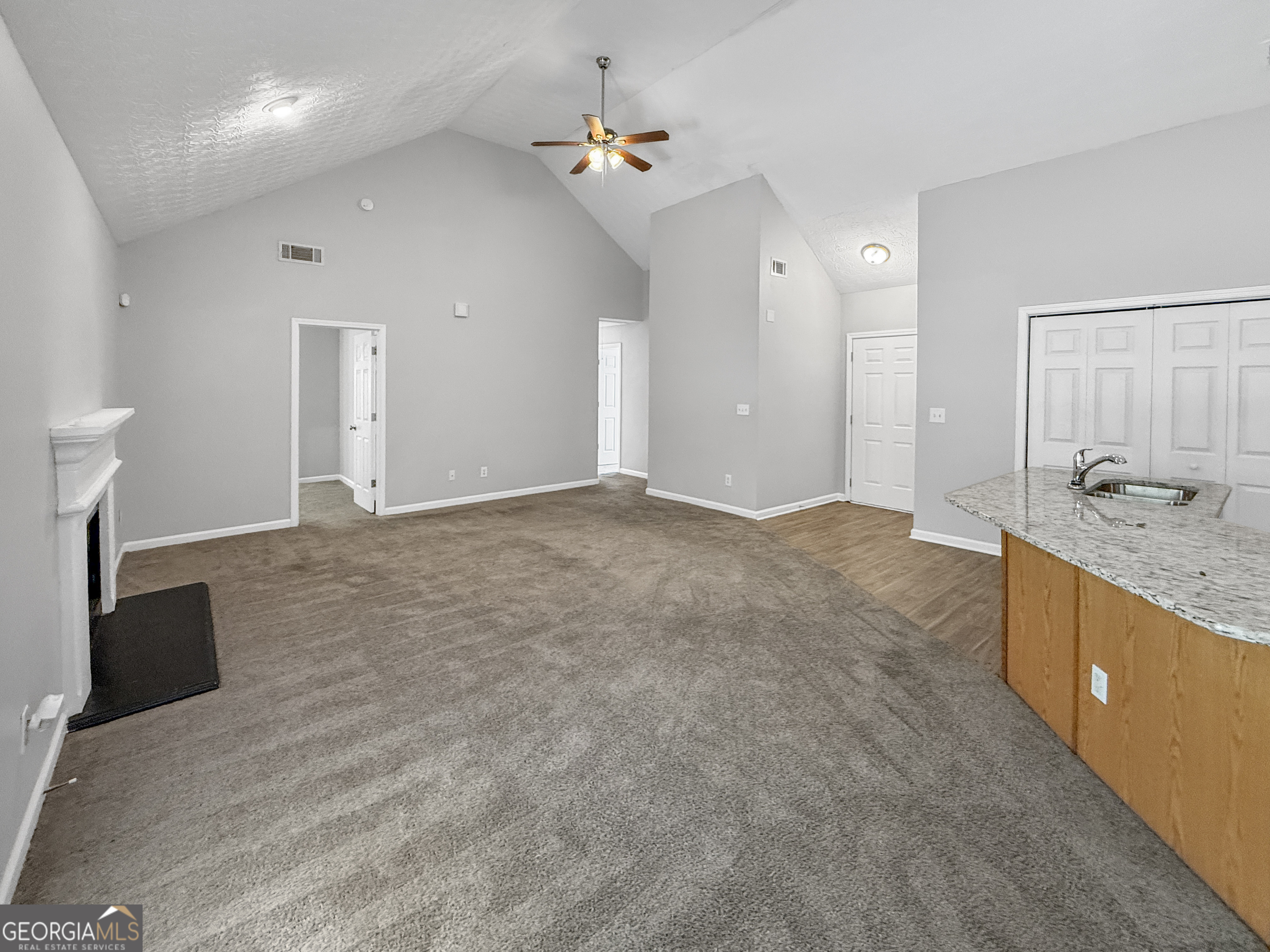 9108 South Sterling Lakes Drive Covington, GA 30014 - Photo 5 of 16 a view of a kitchen with a sink and a vanity