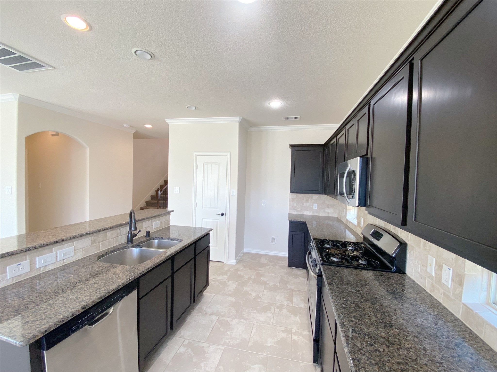 3566 Hamilton Bend Lane Spring, TX 77386 - Photo 12 of 25 a kitchen with granite countertop a sink and a stove top oven
