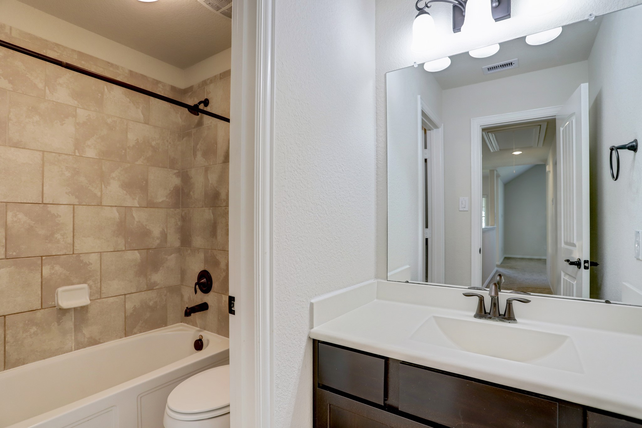 3566 Hamilton Bend Lane Spring, TX 77386 - Photo 22 of 25 a bathroom with a sink a toilet a mirror a bathtub and shower