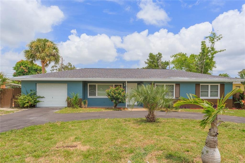 8301 Ridge Road Seminole, FL 33772 - Photo 1 of 1 a front view of a house with garden