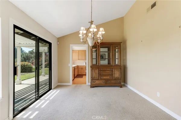 a view of a room with chandelier front door
