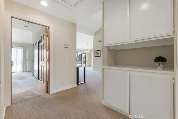 a view of a hallway with some storage and utility room