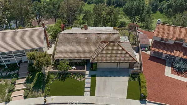 an aerial view of a house with garden and plants