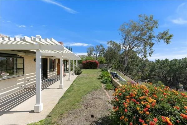 a view of backyard with plants and outdoor seating