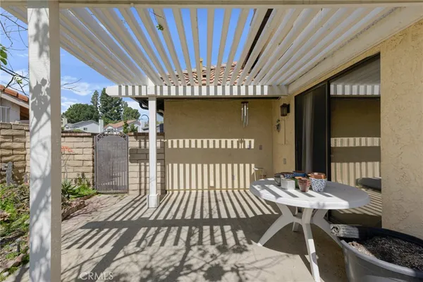 a view of a house with a big yard and potted plants