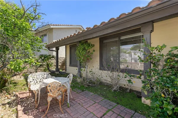 a view of a patio with table and chairs and potted plants