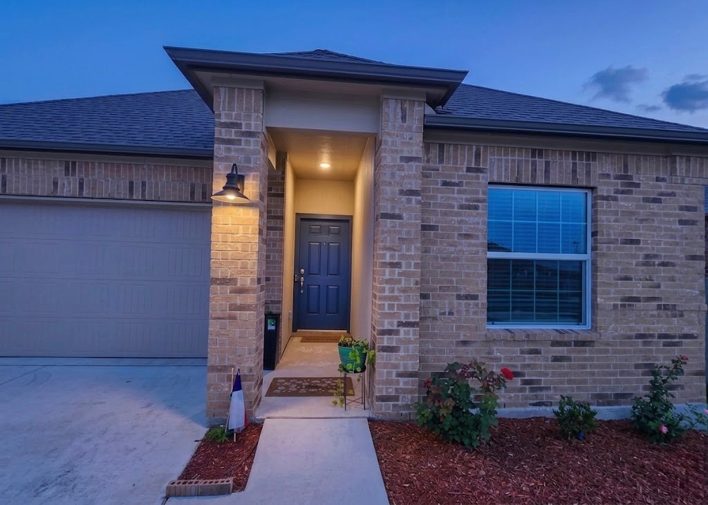 208 Wolf Springs Road Georgetown, TX 78628 - Photo 3 of 32 A well-maintained brick exterior welcomes with an inviting entryway and established landscaping.