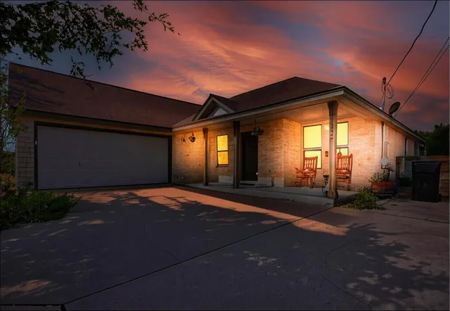 a backyard of a house with table and chairs