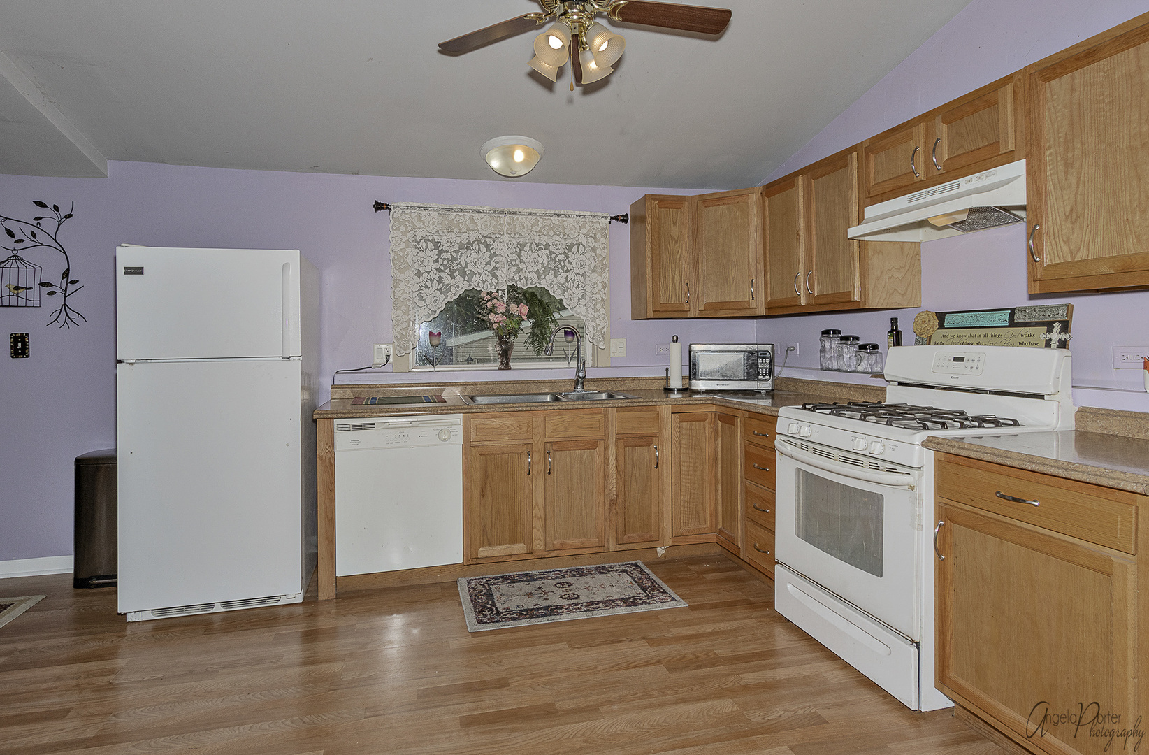 26316 West Rollins Road Ingleside, IL 60041 - Photo 3 of 45 a kitchen with a white cabinets and white appliances