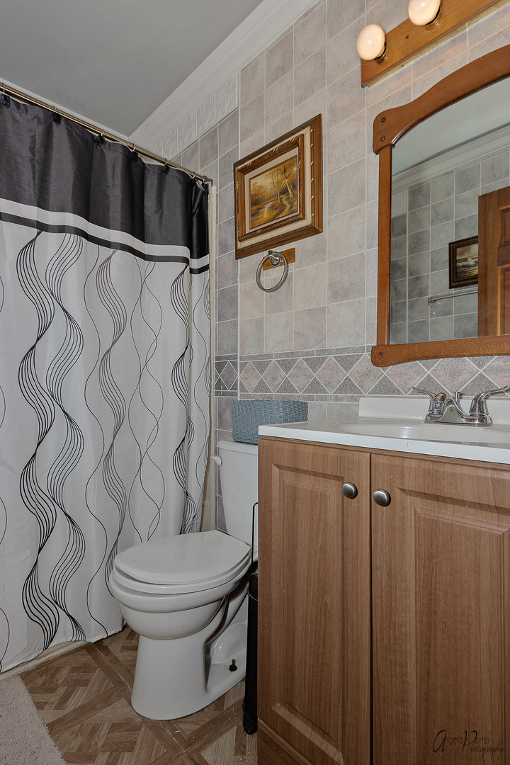 26316 West Rollins Road Ingleside, IL 60041 - Photo 9 of 45 a bathroom with a toilet sink and shower