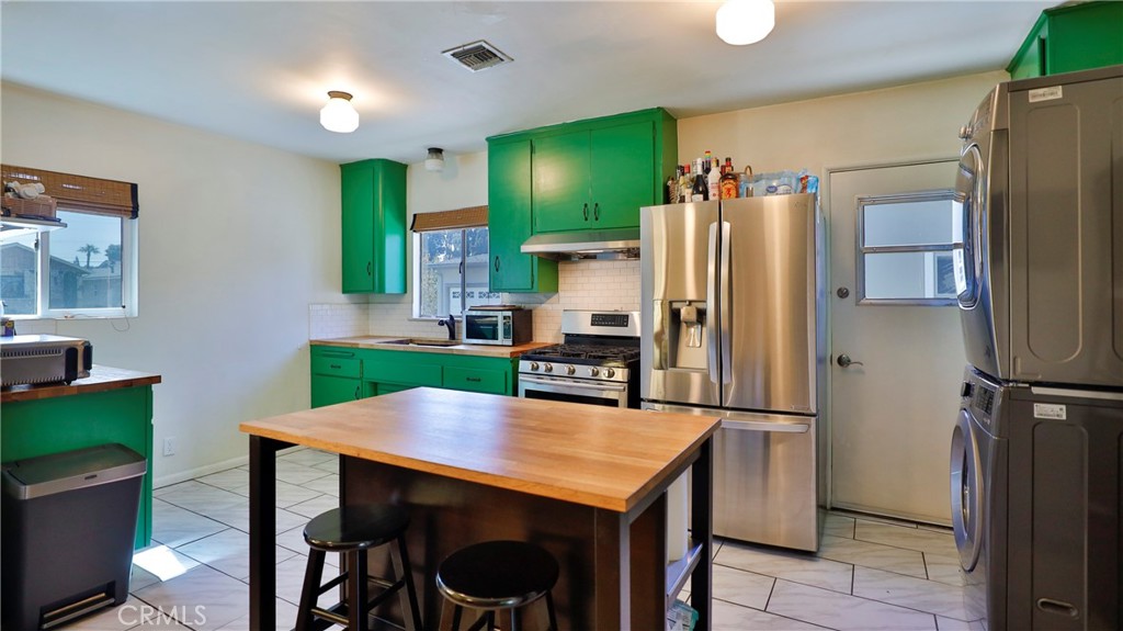 5035 Greer Avenue Covina, CA 91724 - Photo 11 of 37 a kitchen with stainless steel appliances a refrigerator stove microwave and sink
