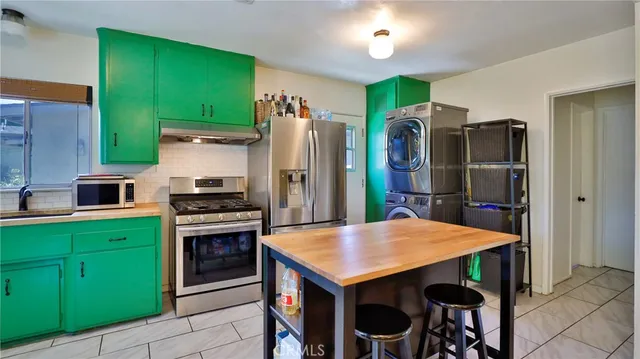 a kitchen with cabinets and stainless steel appliances