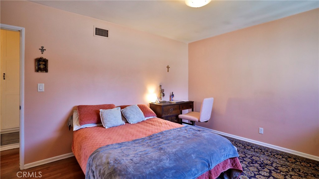 5035 Greer Avenue Covina, CA 91724 - Photo 16 of 37 a bedroom with a bed and wooden floor