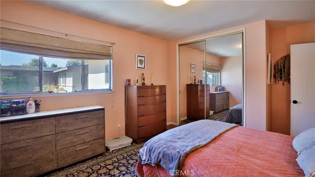 a bedroom with a bed and a dresser