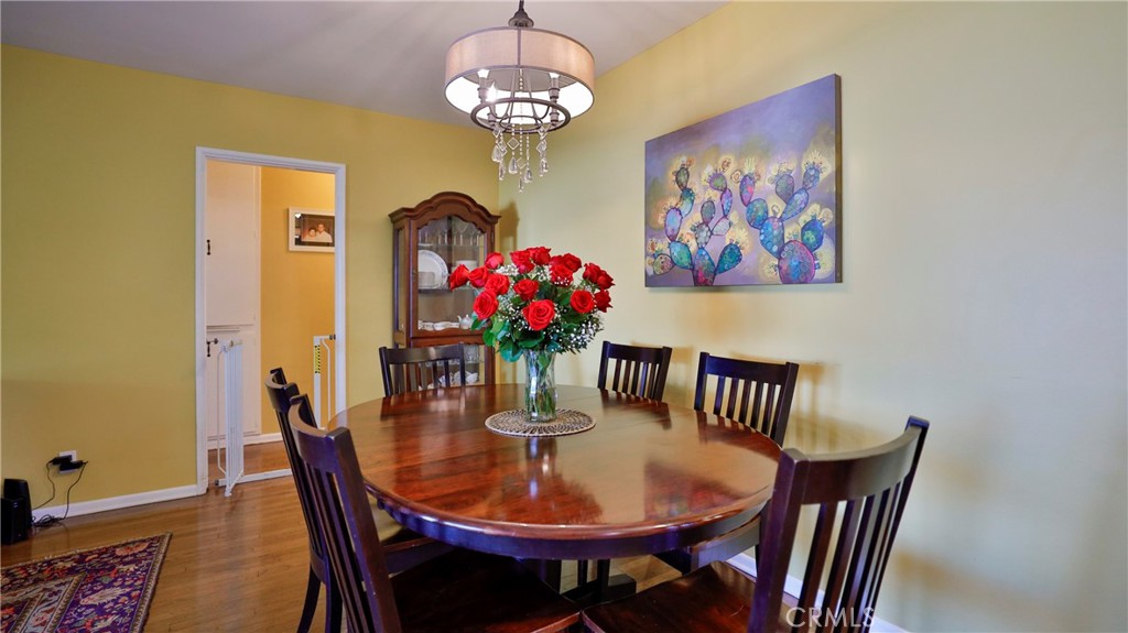 5035 Greer Avenue Covina, CA 91724 - Photo 8 of 37 a view of a dining room with furniture wooden floor and a chandelier