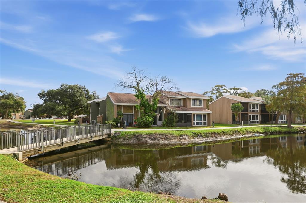 5846 Peregrine Avenue, Unit B12 Orlando, FL 32819 - Photo 22 of 30 a view of residential houses with yard and lake view