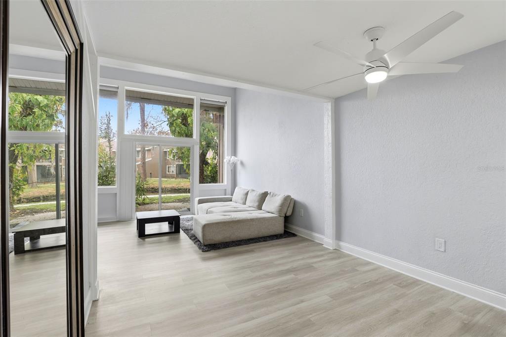 5846 Peregrine Avenue, Unit B12 Orlando, FL 32819 - Photo 10 of 30 a living room with furniture and a large window