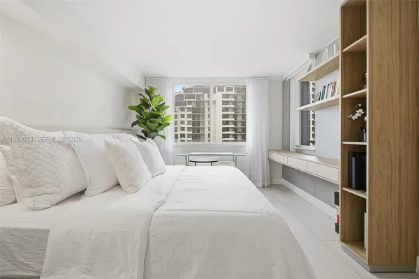 a bedroom with a large bed and a large window