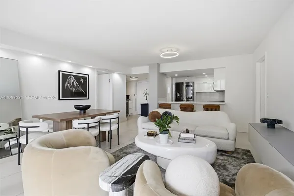 a living room with furniture and view of kitchen