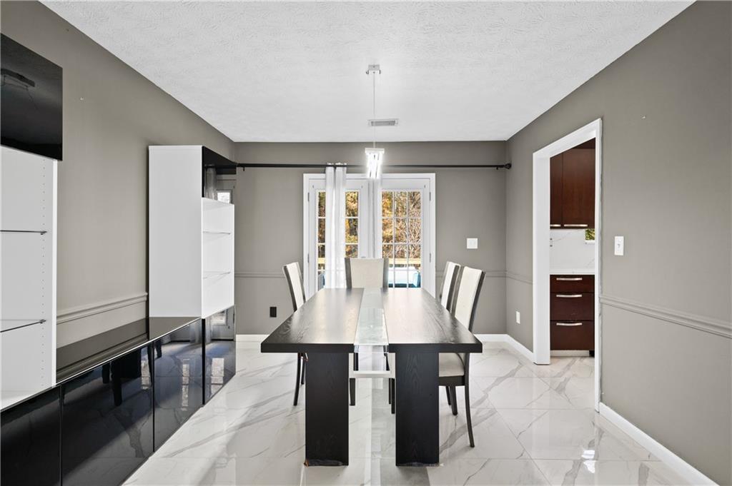 201 Nina Circle Locust Grove, GA 30248 - Photo 11 of 48 a view of a dining room with furniture window and wooden floor