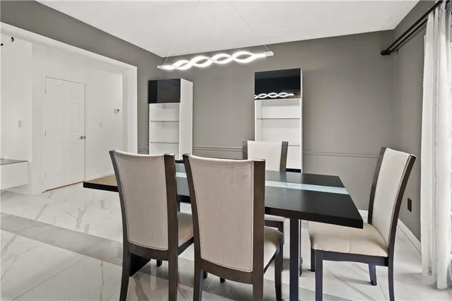 a view of a dining room with furniture and window