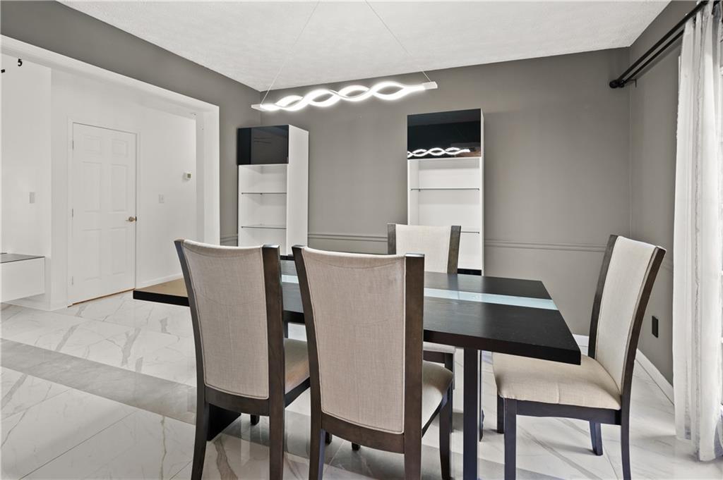201 Nina Circle Locust Grove, GA 30248 - Photo 12 of 48 a view of a dining room with furniture and window