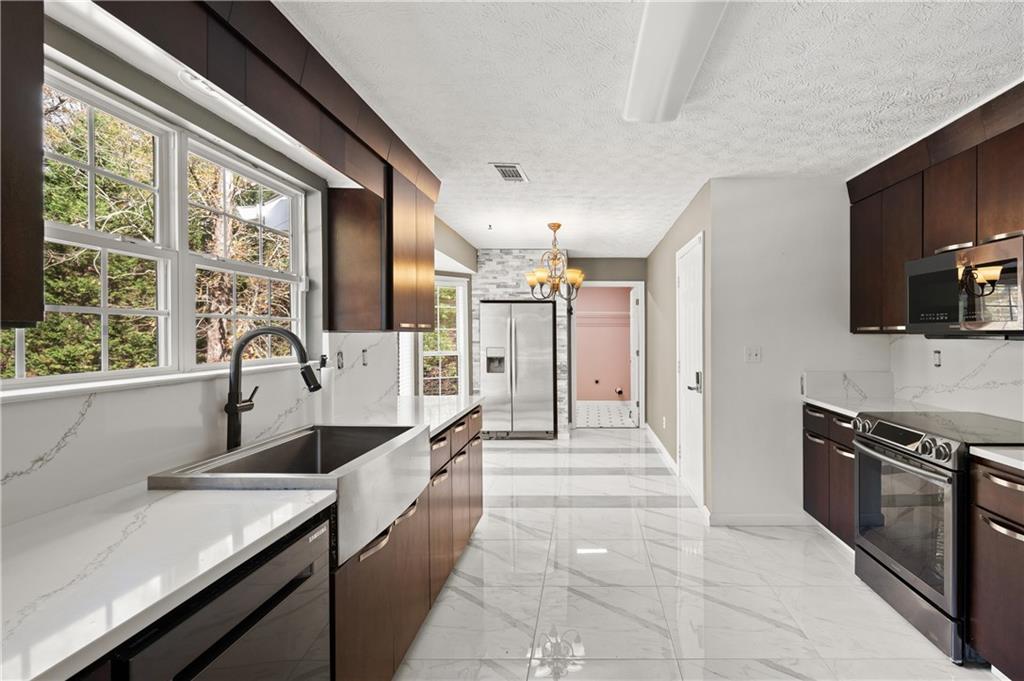 201 Nina Circle Locust Grove, GA 30248 - Photo 13 of 48 a large kitchen with a large window and stainless steel appliances