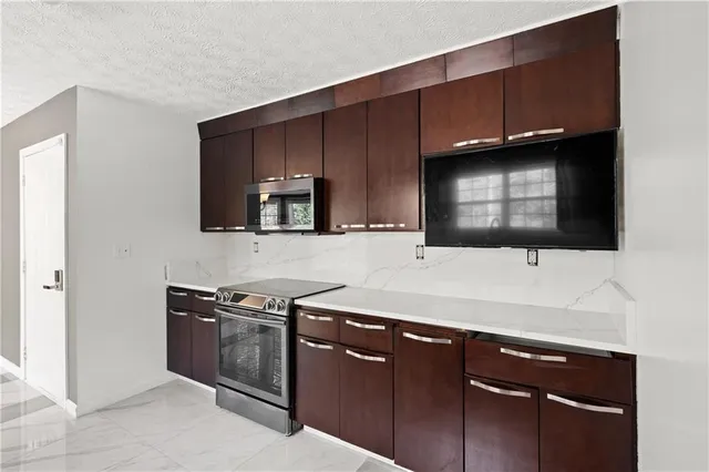 a kitchen with stainless steel appliances wooden cabinets and a sink