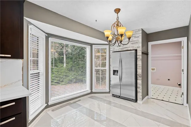 a view of a livingroom with wooden floor and chandelier