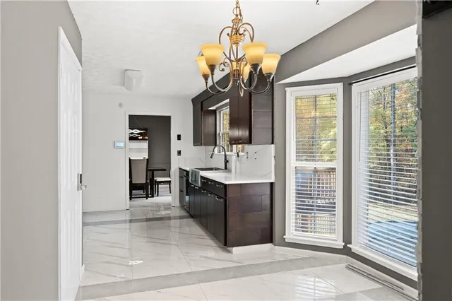 a spacious bathroom with a sink a vanity and a mirror