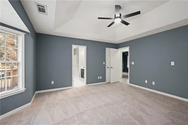 a view of a livingroom with a ceiling fan and window