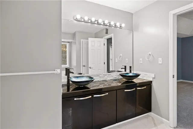 a bathroom with a sink and a mirror