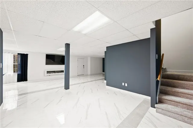 a bedroom with a bed and a television