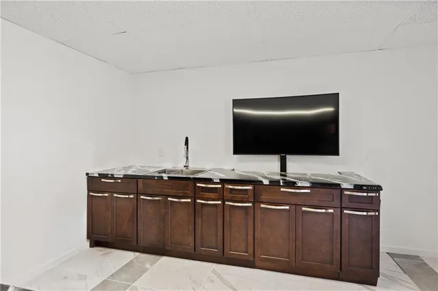 a kitchen with stainless steel appliances granite countertop a sink and cabinets