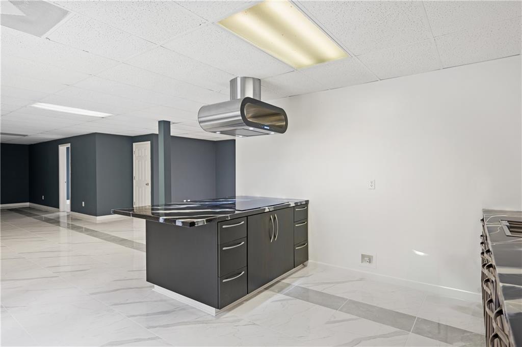 201 Nina Circle Locust Grove, GA 30248 - Photo 34 of 48 a kitchen with stainless steel appliances granite countertop a sink and cabinets