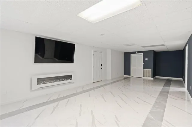 a view of a livingroom with an empty space and a garage